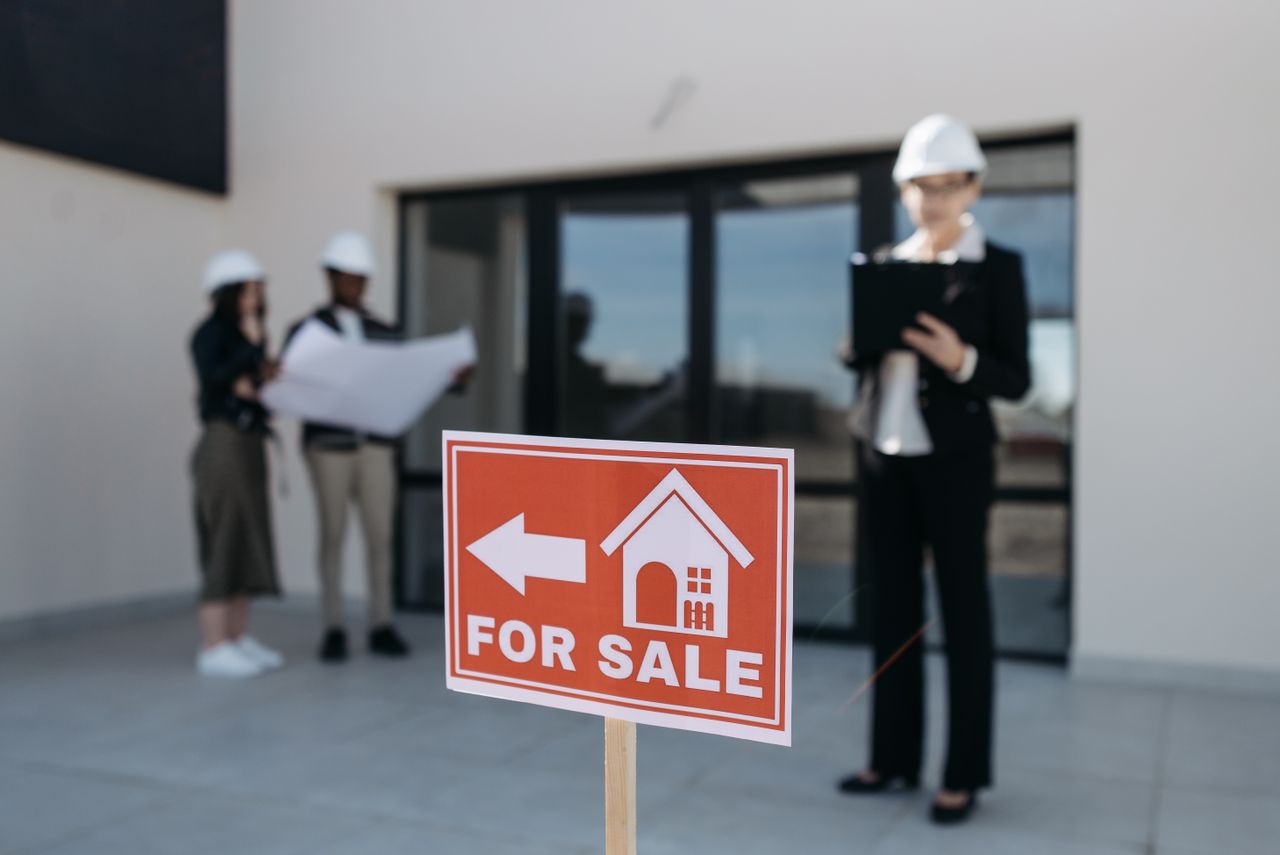 Crafting Captivating Headlines: Your awesome post title goes here Three real estate professionals inspecting a property for sale with a focus on the business aspect.